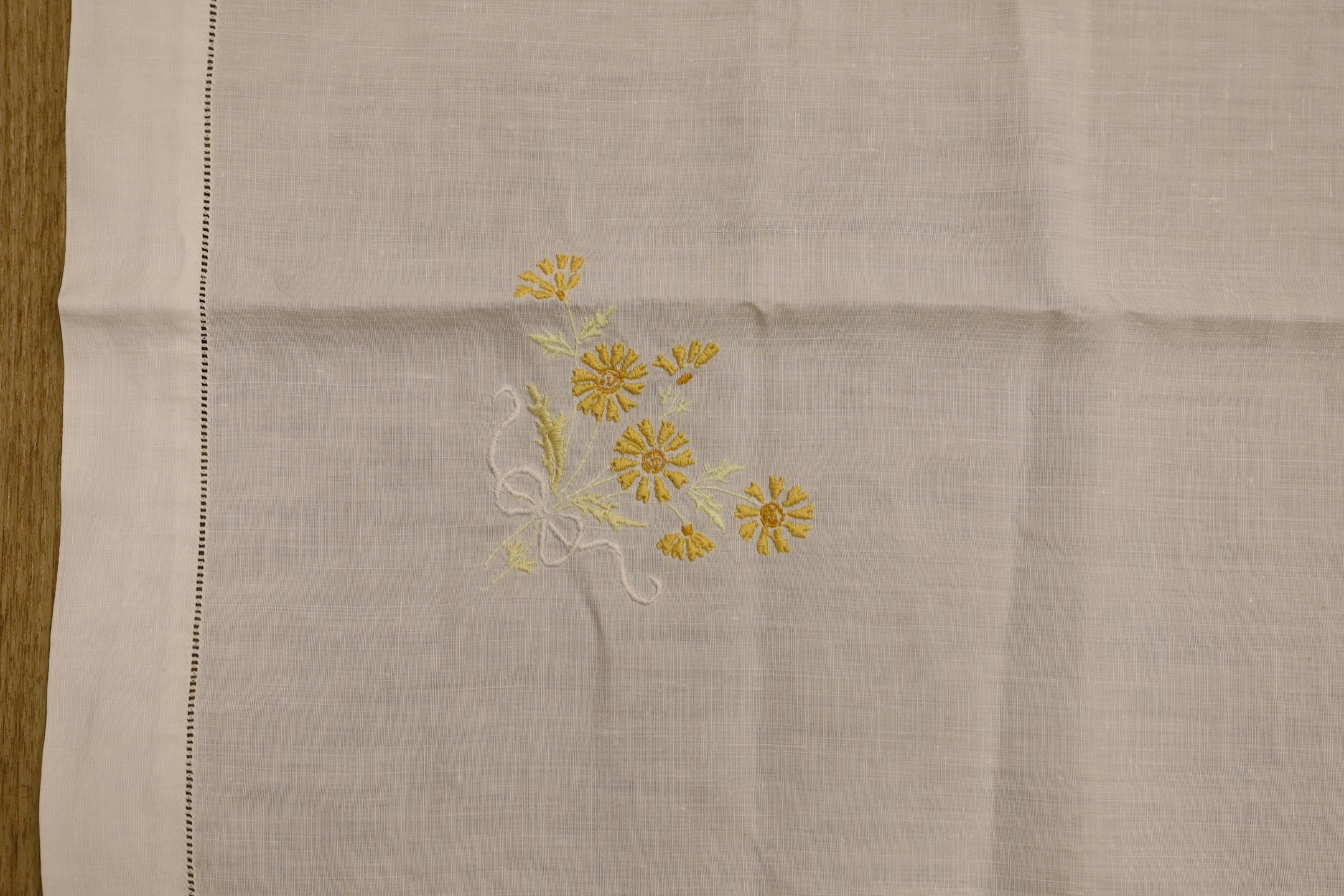 A quantity of lace trimmed and embroidered fabrics including tray cloths and pillow cases